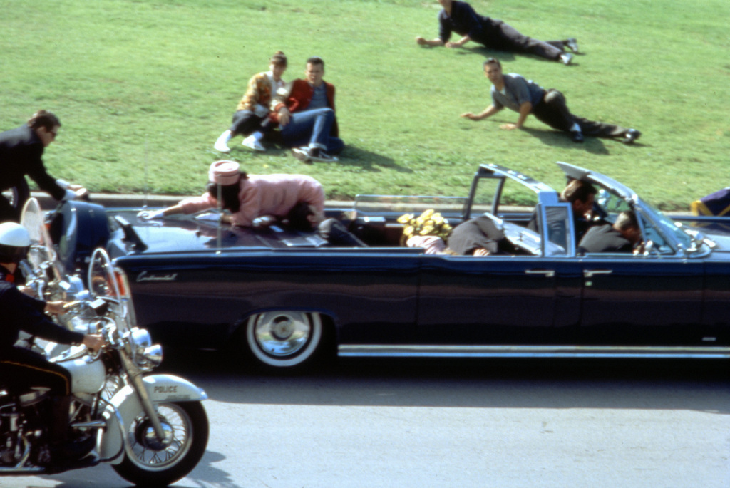This image provided by Warner Bros. from Oliver Stone's 1991 movie "JFK" shows a recreation of the assassination of U.S. President John F. Kennedy in Dallas. "This murder in broad daylight ... Everything changed," says Stone, the Baby Boomer director who served in Vietnam and made a movie about it before turning his critical lens on the Kennedy assassination. (AP Photo/Warner Bros.)