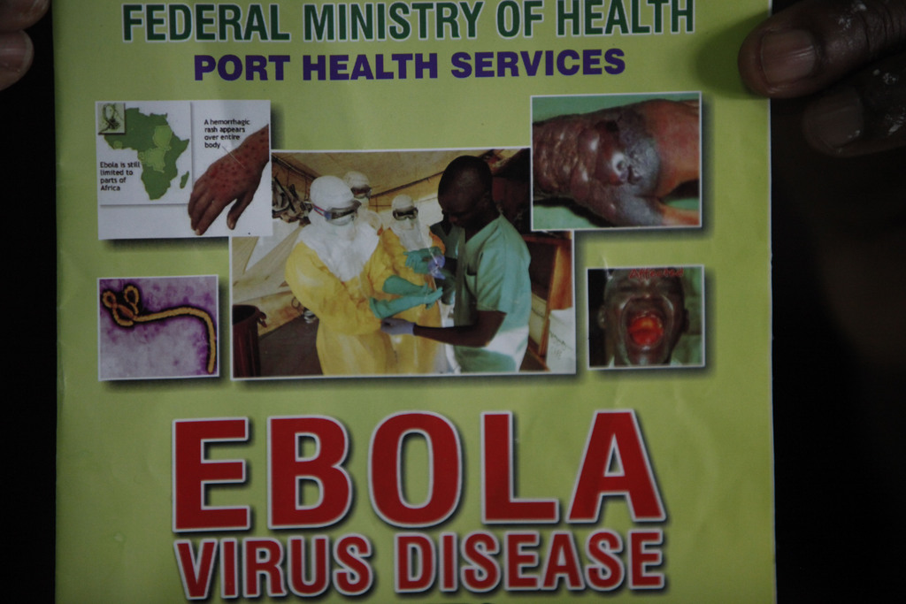 Nigeria health official display a leaflet explaining Ebola Virus Disease at the arrival hall of Murtala Muhammed International Airport in Lagos, Nigeria, Monday, Aug. 4, 2014. Nigerian authorities on Monday confirmed a second case of Ebola in Africa's most populous country, an alarming setback as officials across the region battle to stop the spread of a disease that has killed more than 700 people. (AP Photo/Sunday Alamba)