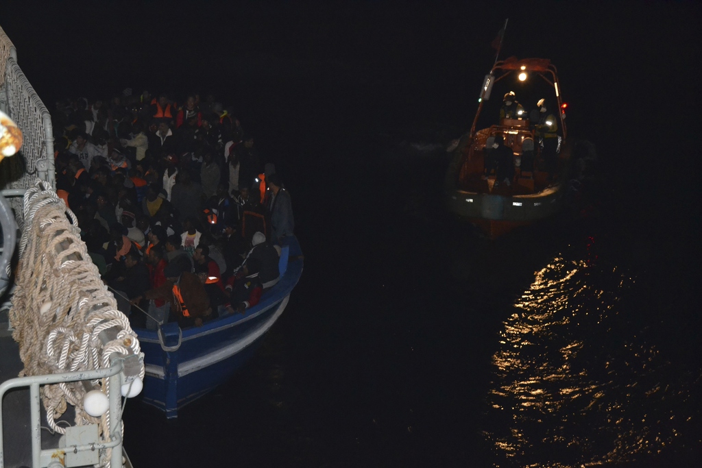 In this photo taken on Friday, Nov. 14, 2014 and provided by the Portoguese Navy, migrants crammed on a wooden boat are rescued off the Lybian coast by a Portoguese Navy vessel. The Portuguese open sea patrol vessel the Viana Do Castelo made its first rescue of migrants as part of Operation Triton, the EU operation that has stepped in to help Italy patrol its coastline. A spokeswoman for Frontex, the European Agency that coordinates Triton deployment, told the Associated Press that in recent days Operation Triton has rescued over 600 migrants. The European Operation Triton is taking over from the Italian Operation Mare Nostrum which was launched by the Italian government in October of 2013, following a migrant shipwreck that left over 300 people dead just off the coast of Lampedusa, the small strip of island that is part of Italy but closer to the African mainland. (AP Photo/Portuguese Navy, ho)