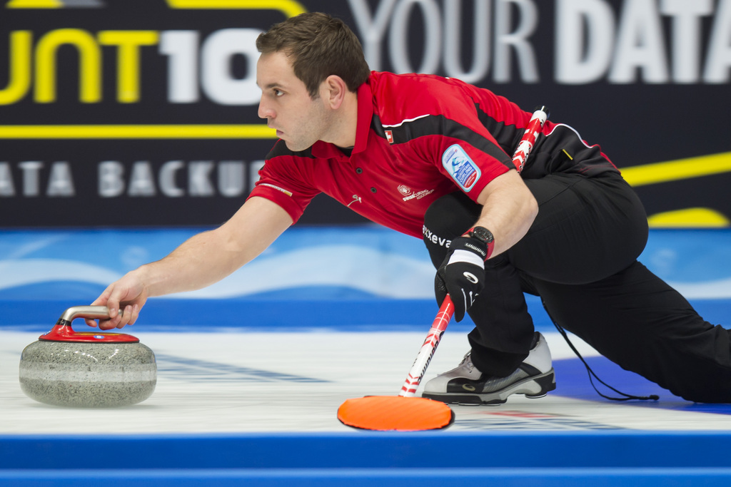 Skip Sven Michel of Switzerland, plays a stone against Russia during the men's qualification round match of the European Curling Championships 2014, at the Palladium Ice Arena, in Champery, Switzerland, Saturday, November 22, 2014. (KEYSTONE/Jean-Christophe Bott)