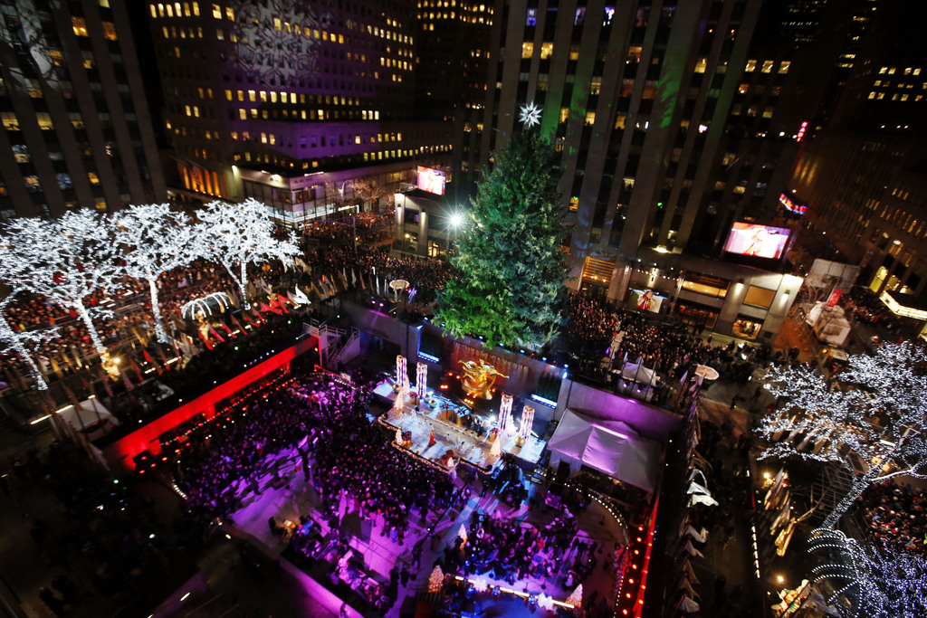 Singer Mariah Carey performs during a lighting ceremony for the Rockefeller Center Christmas tree, Wednesday, Dec. 3, 2014, in New York.  Weighing in at approximately 13 tons, the 85-foot tall, 90-year-old Norway Spruce will be adorned with 45,000 energy efficient LED lights. (AP Photo/Jason DeCrow)