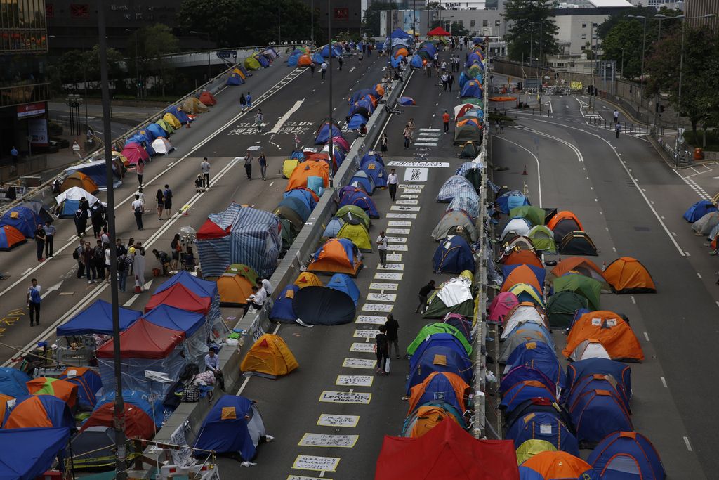 In this Wednesday, Oct. 29, 2014 photo, pro-democracy protesters camp in the occupied areas outside government headquarters in Hong Kong's Admiralty. Even as protesters remain locked in a weeks-long stalemate with city officials over demands for electoral reforms, political analysts say this 7.2 million-person financial capital could be seeing the birth of a newly awakened generation that will continue demanding democracy and take to the streets to push for it. (AP Photo/Kin Cheung)