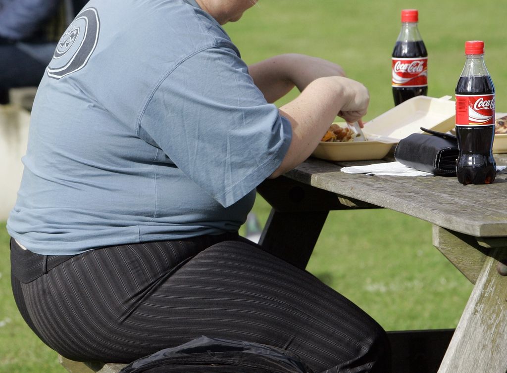 FILE- In this file photo dated Wednesday, Oct. 17, 2007, an overweight person eats in London, Wednesday, Oct. 17, 2007.  Almost a third of the world population is now fat, and no country has been able to curb obesity rates in the last three decades, according to a new global analysis released Thursday May 29, 2014,  led by Christopher Murray of the Institute for Health Metrics and Evaluation at the University of Washington, USA, and paid for by the Bill & Melinda Gates Foundation.  Researchers reviewed more than 1,700 studies covering 188 countries covering over three decades and found more than 2 billion people worldwide classified as overweight or obese. The highest rates of obesity were found in the Middle East and North Africa, with the U.S. having about 13 percent of the world?s fat population. (AP Photo/Kirsty Wigglesworth, FILE)