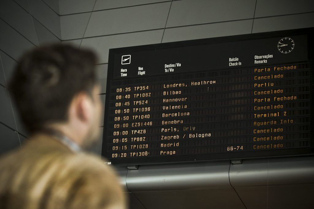 epa04469747 A passenger looks at an electronic box in the boarding area of Lisbon airport showing canceled flights during a wokers strike in Lisbon, Portugal, 30 October 2014. TAP workers called a 24-hours strike protesting on working conditions and demanding changes on company's management.  EPA/MARIO CRUZ