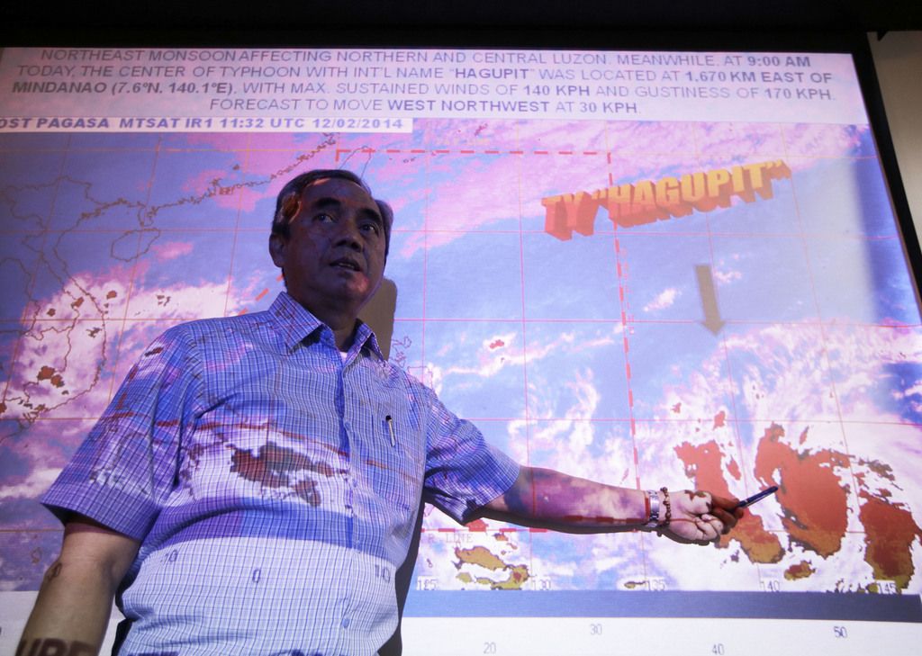Alexander Pama, chief of the National Disaster Risk Reduction Management Council, points to the satellite image of Typhoon Hagupit which is brewing over the Pacific Ocean during a media briefing on the Government agency's readiness in dealing with a possible strong weather disturbance Wednesday, Dec. 3, 2014 at suburban Quezon city northeast of Manila, Philippines. The Philippines weather bureau is advising the public to brace for Typhoon Hagupit which continues to gead towards the central Philippines and looking at the possibility it might hit the same areas as super Typhoon Haiyan which devastated Tacloban last year. (AP Photo/Bullit Marquez)