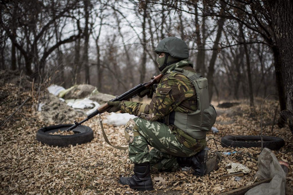 A Ukrainian serviceman gets ready to fire at his position next to a bridge over the river Siverskiy Donets, damaged by explosion during fighting between Pro-Russian rebels and Ukrainian government forces near Trehizbenka village, Luhansk region eastern Ukraine, Sunday, November. 23, 2014. More than 4,300 people have died in fighting in eastern Ukraine over the past half year, according to U.N. estimates. (AP Photo/Evgeniy Maloletka)