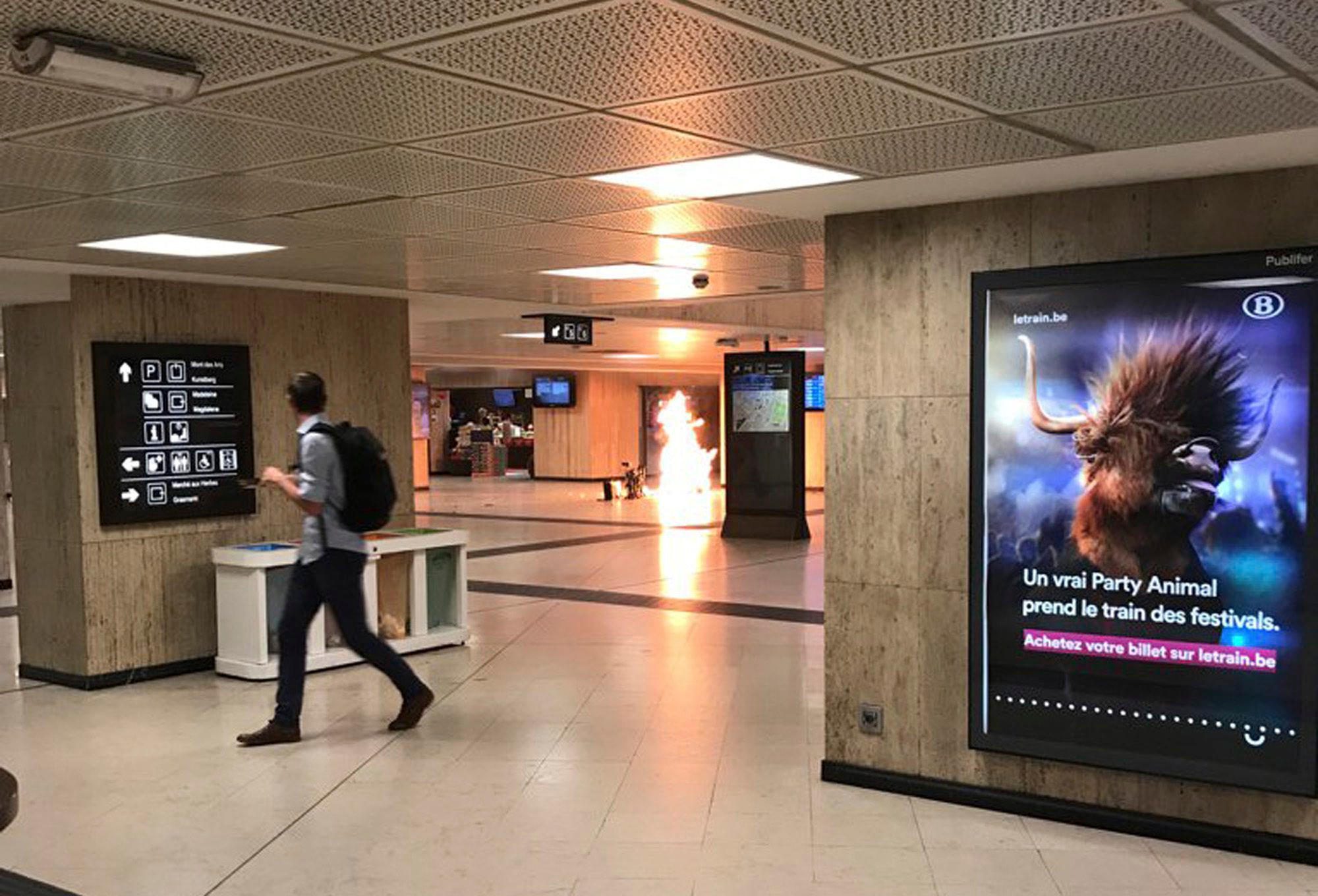 In this June 20, 2017 photo a man blows up an explosive device in the station in Brussels. The man was shot by soldiers afterwards in what prosecutors are treating as a "terrorist attack." He lay still for several hours while a bomb squad checked whether he was carrying more explosives and later died. No one else was hurt. (Remy Bonnaffe via AP)  MANDATORY CREDIT Belgium Station Explosion