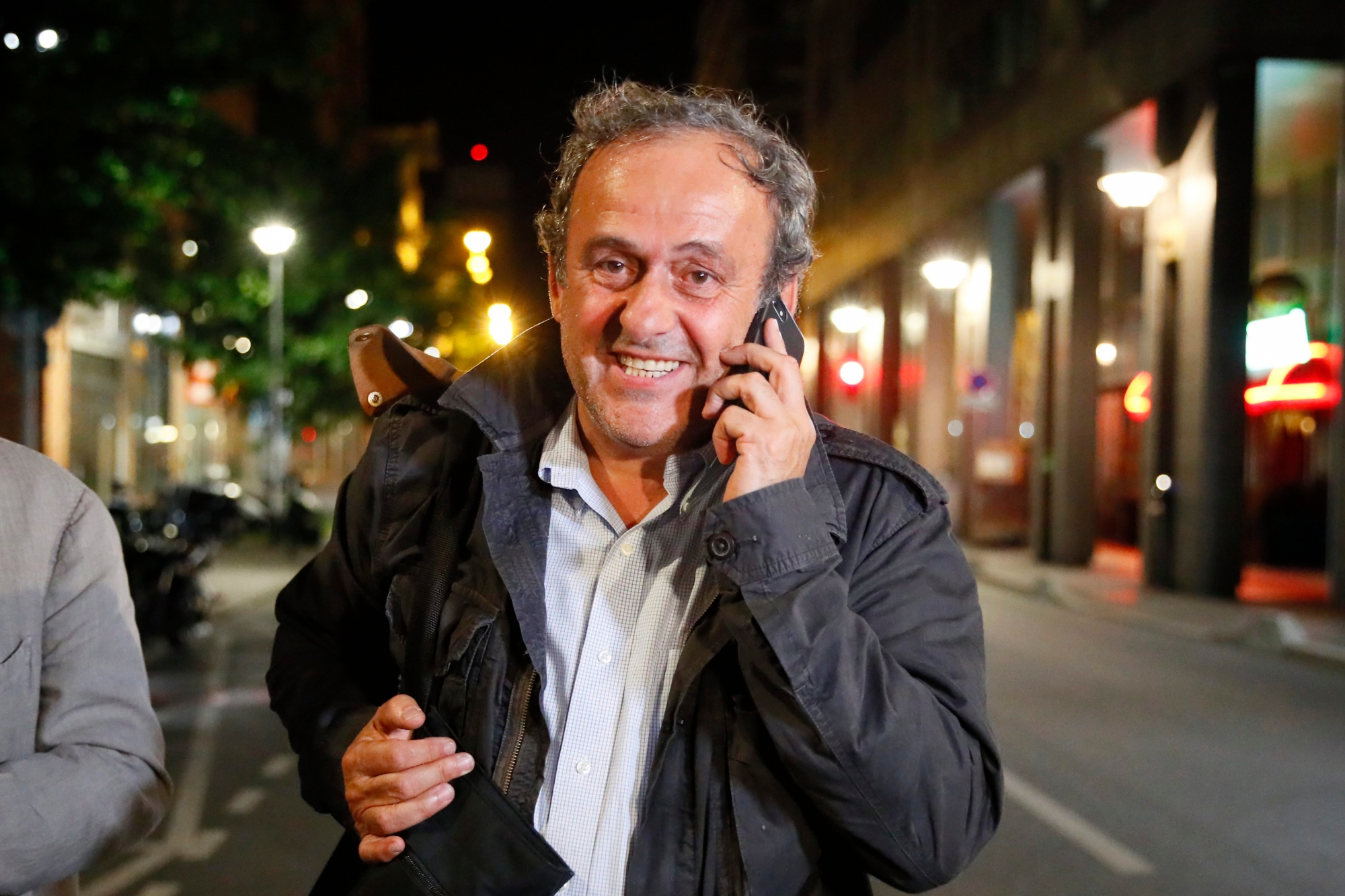 Michel Platini makes a phone call after being freed, outside the French police anti-corruption and financial crimes office in Nanterre, outside Paris, early Wednesday, June 19, 2019. Former UEFA president Michel Platini proclaimed his innocence during police questioning Tuesday following his arrest as part of a corruption probe into the vote that gave the 2022 World Cup to Qatar. (AP Photo/ Francois Mori) APTOPIX France Platini Arrested