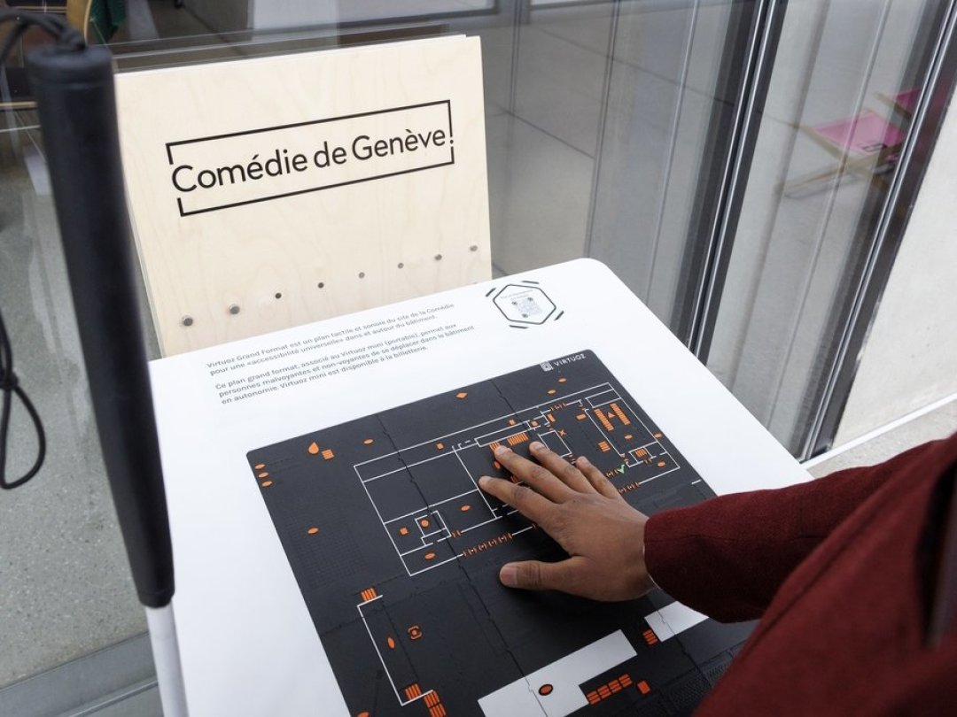 Saliou Sangare, malvoyant et testeur du dispositif Virtuoz, fait une démonstration du grand format de l'application tactile, lors de l'inauguration du dispositif à la Comédie de Genève, ce lundi 21 novembre.