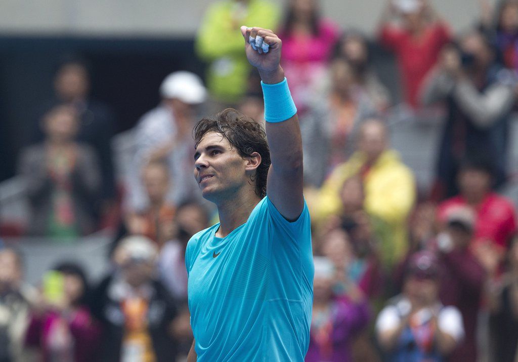 Rafael Nadal of Spain acknowledges the spectators after defeating Fabio Fognini of Italy during the quarterfinal match of the China Open tennis tournament at the National Tennis Stadium in Beijing, China Friday, Oct. 4, 2013. (AP Photo/Andy Wong)