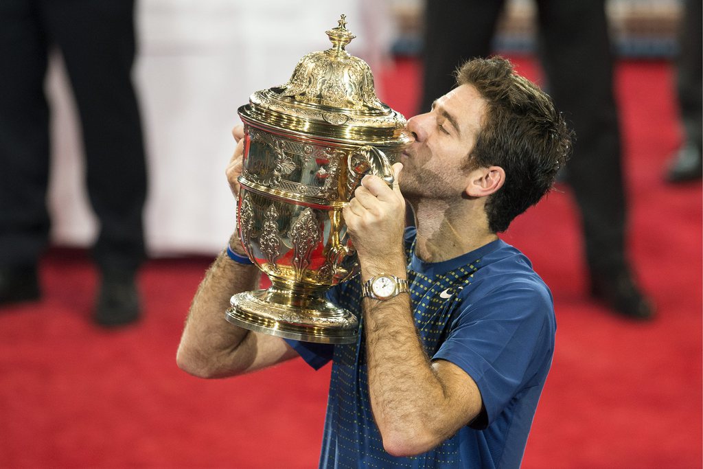Argentina's Juan Martin Del Potro cheers with the trophy at the award ceremony after the final match against Switzerland's Roger Federer at the Swiss Indoors tennis tournament at the St. Jakobshalle in Basel, Switzerland, on Sunday, October 27, 2013. (KEYSTONE/Georgios Kefalas)