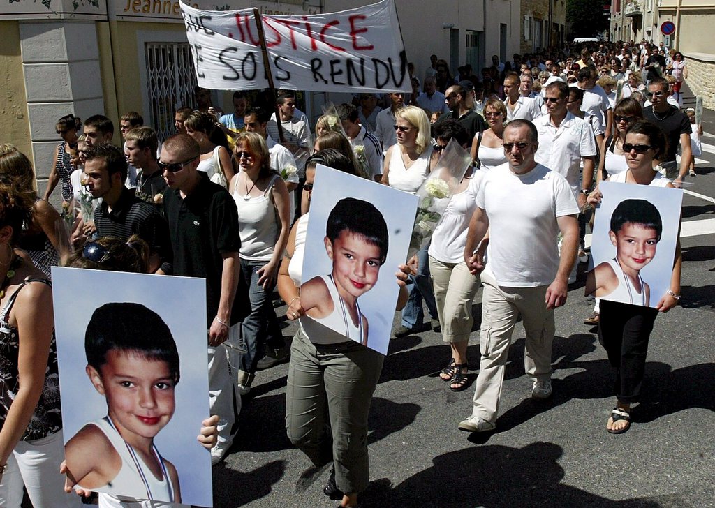 epa01430293 Inhabitants of Porcieu-Amblagnieu, France, 03 August 2008, some of them carrying the victim's portraits, march in silence through the town to protest the killing of Valentin, an 11-year-old boy stabbed to death on 29 July in the French town of Lagnieu. The 'white march' was staged in  the victim's home town. A French prosecutor issued a detention order for Stephane Moitoiret and his companion Noella Hego, suspected of the murder of Valentin after ADN tests were performed.  EPA/JEAN FRANCOIS SOUCHET FRANCE OUT, BELGIUM OUT