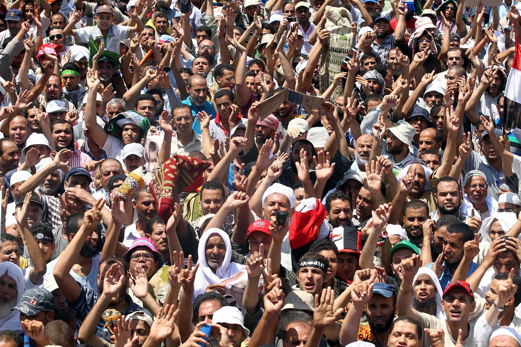 epa03820700 Supporters of the Muslim Brotherhood attend a protest in support of ousted Egyptian President Mohamed Morsi outside the Rabaa al-Adawiya mosque, in Cairo, Egypt, 11 August 2013. Morsi and Muslim Brotherhood supporters intend to hold more rallies calling for a reinstatement of ousted President Morsi. Egypt's interim government insisted they will disband the protest camps after Eid al-Fitr, the Muslim holiday marking the end of Ramadan the same day.  EPA/KHALED ELFIQI
