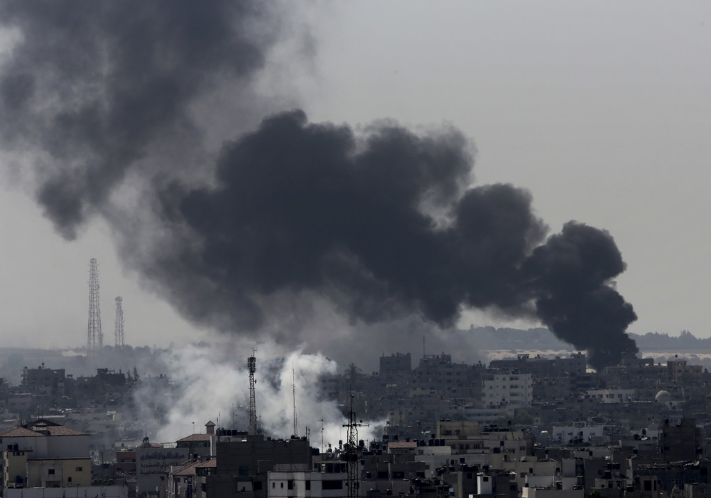 Smoke from Israeli strikes rises over Gaza City, in the northern Gaza Strip, Sunday, July 27, 2014. Israel resumed its Gaza offensive on Sunday, calling off a unilateral extension of a humanitarian cease-fire after Palestinian militants fired several rockets at southern Israel. The rocket fire began late Saturday after Gaza's Hamas rulers, who have demanded the lifting of an Israeli and Egyptian blockade on the territory and the release of prisoners, refused to extend the truce. (AP Photo/Adel Hana)