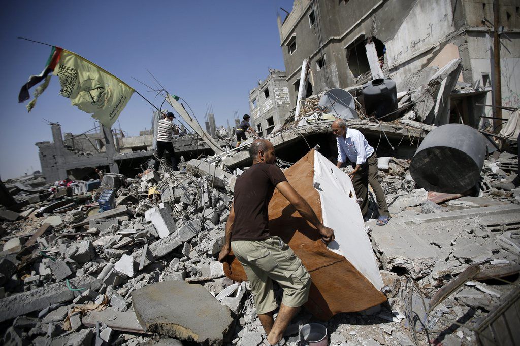 epa04337447 Palestinian men inspect the ruble of their destroyed houses in Beit Hanun town, in the northern Gaza Strip, 01 August 2014. A 72-hour humanitarian ceasefire between Israel and Palestinian militant groups in the Gaza Strip broke down on 01 August 2014, less than three-hours after taking effect, with at least 35 Palestinian killed in the south of the enclave. Israel and Hamas, the dominant militant group in Gaza, traded blame violating the ceasefire, which ended after heavy clashes in the southern area of Rafah near the border with Egypt. Israeli officials informed the United Nations the three-day truce had ended, local media reported.  EPA/MOHAMMED SABER