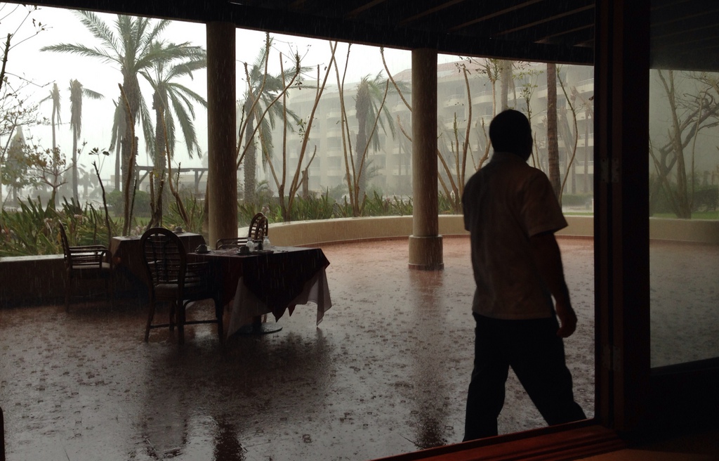 A waiter walks near tables while it rains at a hotel in San Jose de los Cabos, Mexico, Saturday, Sept. 20, 2014. Tropical Storm Polo churned south of the Baja California Peninsula on Saturday, whipping up waves and swirling more rain onto residents still recovering from Hurricane Odile. (AP Photo/Dario Lopez-Mills)