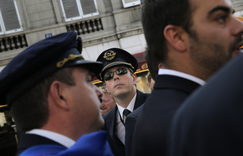 Air France pilots attend a demonstration in Paris, Tuesday, Sept. 23, 2014. France?s prime minister  speaking out against Air France pilots who are striking for an eighth day over the proposed expansion of its low-cost carrier, Transavia. Air France-KLM airline says the strike is costing up to euro20 million  ($25 million) a day. The company is cutting costs to try to stay competitive with budget airlines. About half the airline?s flights have been cancelled. (AP Photo/Christophe Ena)