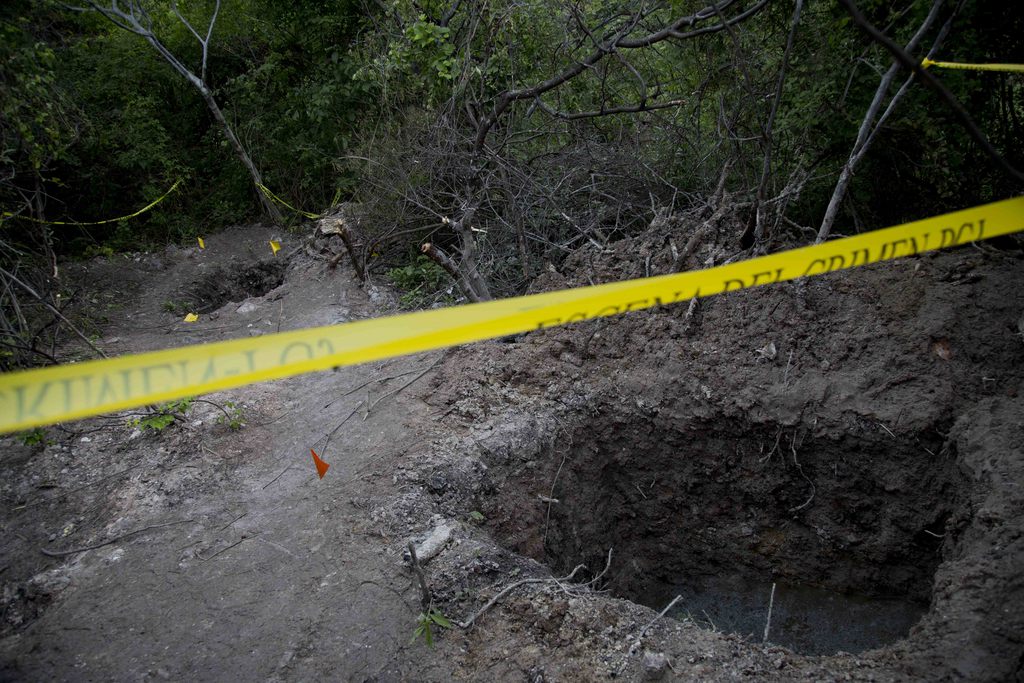 Clandestine graves are seen in Iguala, Mexico, Monday, Oct. 6, 2014. State officials worked Monday to determine whether 28 bodies found in the clandestine graves are of the students who were attacked by local police in Iguala. President Enrique Pena Nieto called the deaths "outrageous, painful and unacceptable."  (AP Photo/Eduardo Verdugo)