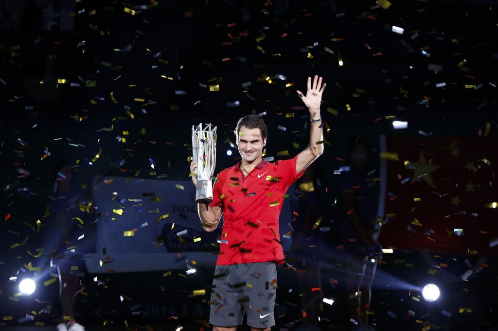 Roger Federer of Switzerland holds the trophy during awards ceremony after the men's singles final against Gilles Simon of France at the Shanghai Masters Tennis Tournament in Shanghai, China, Sunday, Oct. 12, 2014.  (AP Photo/Vincent Thian)