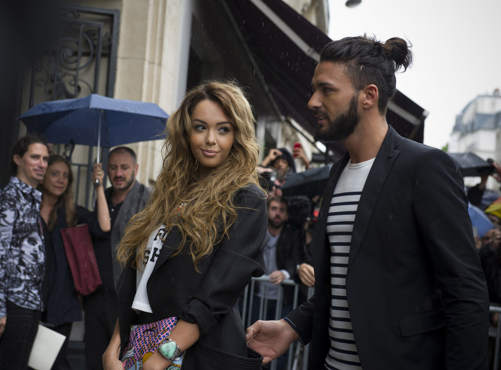 Nabilla Benattia, left, and Thomas Vergara, arrive to attend the Jean-Paul Gaultier Fall Winter 2014-15 Haute Couture fashion collection, presented in Paris, Wednesday, July 9, 2014. (AP Photo/Zacharie Scheurer)