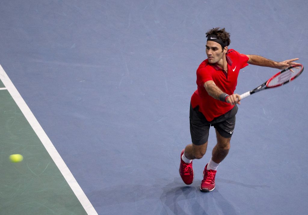 Roger Federer of Switzerland returns the ball to France's Lucas Pouille during their third round match at the ATP World Tour Masters tennis tournament at Bercy stadium in Paris, France, Thursday, Oct. 30, 2014.(AP Photo/Jacques Brinon)