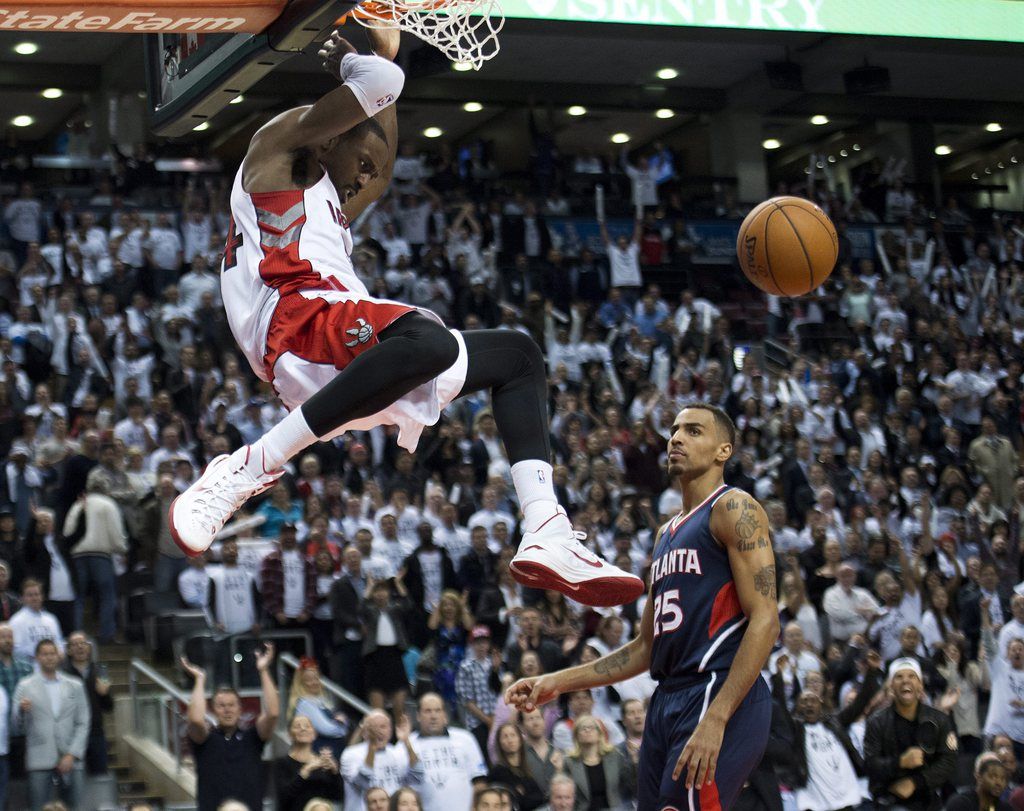 Toronto Raptors forward Patrick Patterson, left, dunks the ball past Atlanta Hawks forward Thabo Sefolosha, right, during the second half of an NBA basketball game in Toronto on Wednesday, Oct. 29, 2014. (AP Photo/The Canadian Press, Nathan Denette)