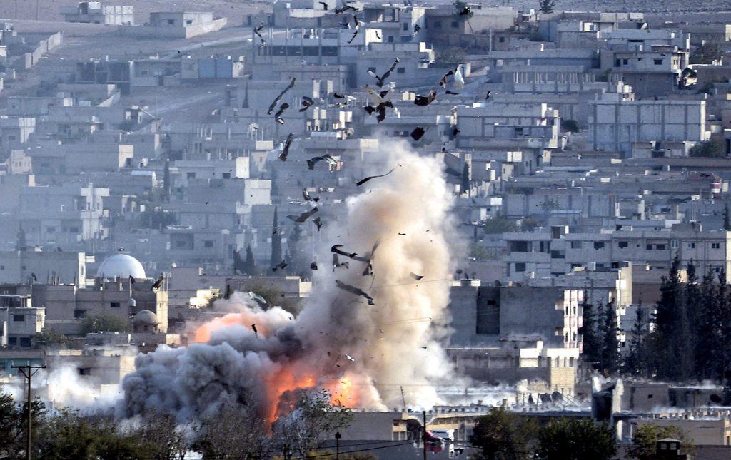 epa04466064 An explosion after an apparent US-led coalition airstrike on Kobane, Syria, as seen from the Turkish side of the border, near Suruc district, Sanliurfa, Turkey, 27 October 2014.  Kurdish rebels have regained a strategic hill in the town of Kobane in northern Syria from the Islamic State after heavy airstrikes by the US-led coalition against the militant group, the Kurdish Rudaw news agency have reported. The United States and Arab allies have intensified their aerial campaign against the Islamic State in Kobane after the radical group gained ground around the mostly Kurdish town in recent days.  EPA/ERDEM SAHIN