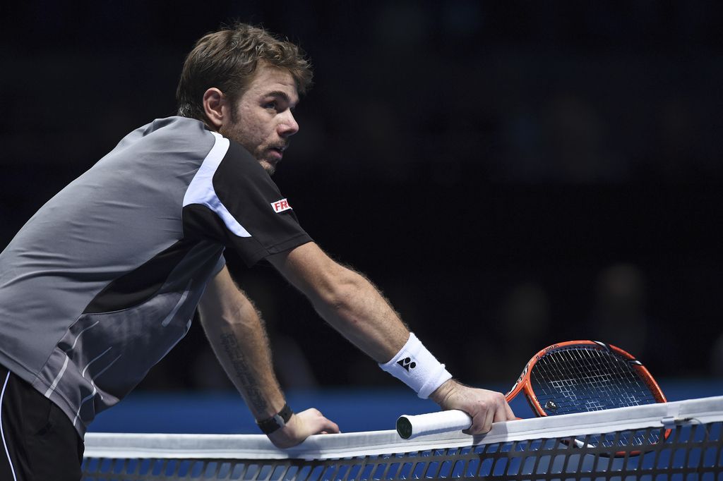 Switzerland?s Stan Wawrinka leans on the net during his ATP World Tour Finals semifinal tennis match against his compatriot Roger Federer at the O2 Arena in London Saturday, Nov. 15, 2014. (AP Photo/Tim Ireland)