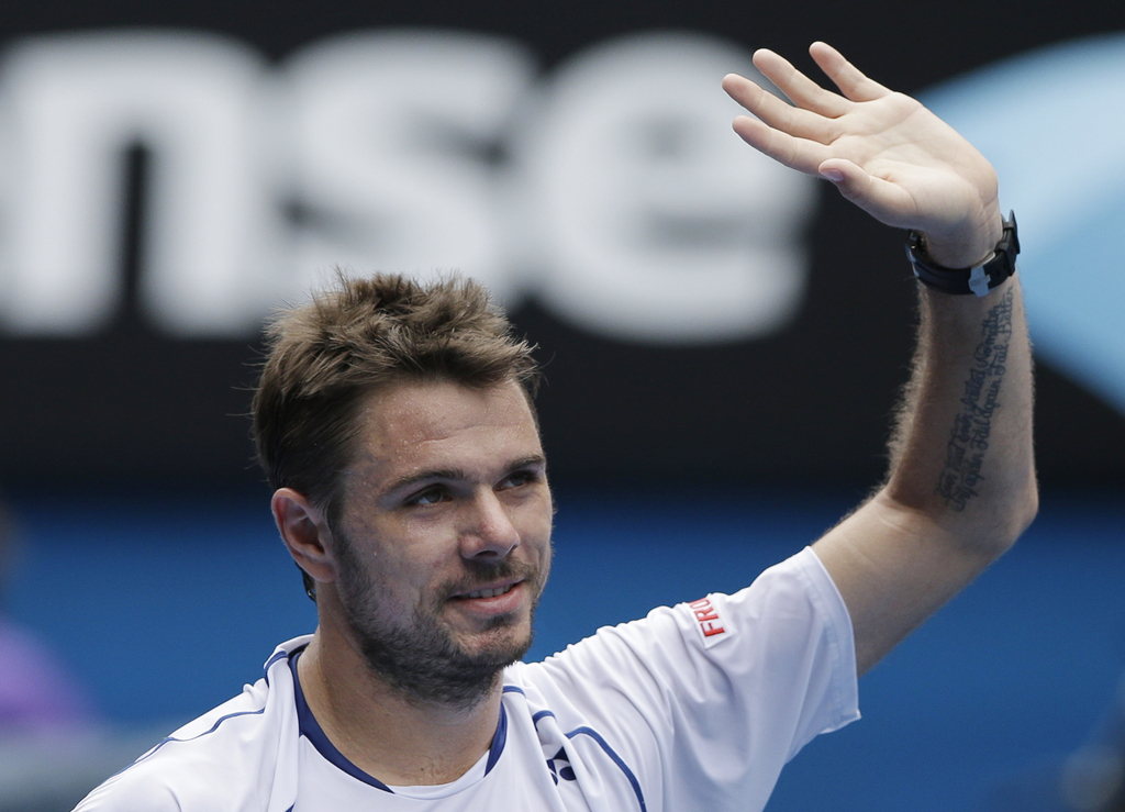 Stan Wawrinka of Switzerland celebrates after beating Turkey?s Marsel Ilhan during their first round match at the Australian Open tennis championship in Melbourne, Australia, Tuesday, Jan. 20, 2015. (AP Photo/Lee Jin-man)