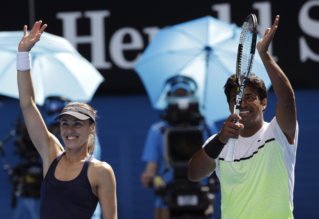 Martina Hingis of Switzerland, left,  and Leander Paes of India wave after defeating Hsieh Su-Wei of Taiwan and Pablo Cuevas  of Uruguay in their mixed doubles semifinal match at the Australian Open tennis championship in Melbourne, Australia, Friday, Jan. 30, 2015. (AP Photo/Lee Jin-man)