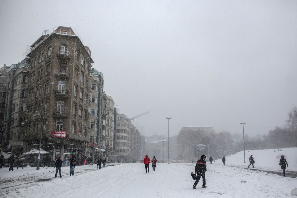 People walk during a heavy blizzard in central Istanbul, Turkey, Wednesday, Feb. 18, 2015. Turkey's largest city has been hit by a storm that has dumped up to a 60 centimeters (24 inches) of snow in some areas since Tuesday, wreaking havoc on roads.(AP Photo/Mosa'ab Elshamy)