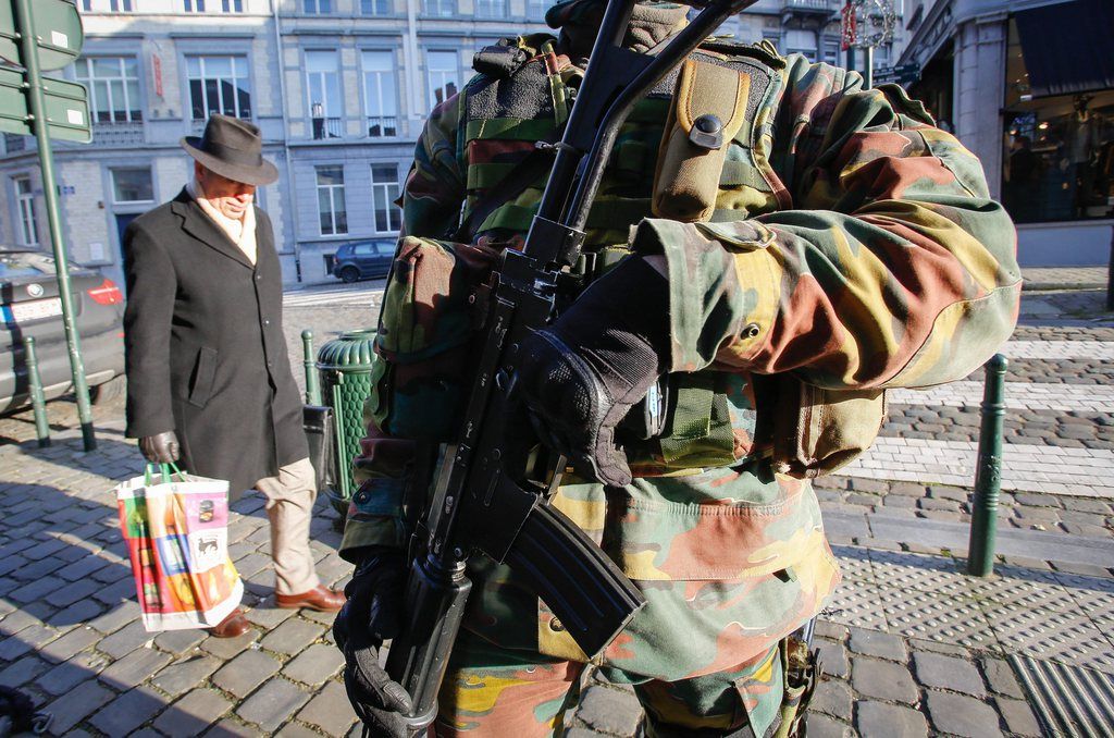 epa04564698 Armed Belgian Military soldiers guard the streets near the Jewish Museum in Brussels, Belgium, 17 January 2015. Thirteen people have been detained in 12 anti-terrorism raids in the Belgian city of Verviers, as well as in and around Brussels late 15 January, federal prosecutors said. In Verviers, where two suspects were killed, officers found four Kalashnikov AK-47s, four handguns, police uniforms and explosives, as well as false documents and a large amount of money, a prosecution spokesman said.  EPA/JULIEN WARNAND