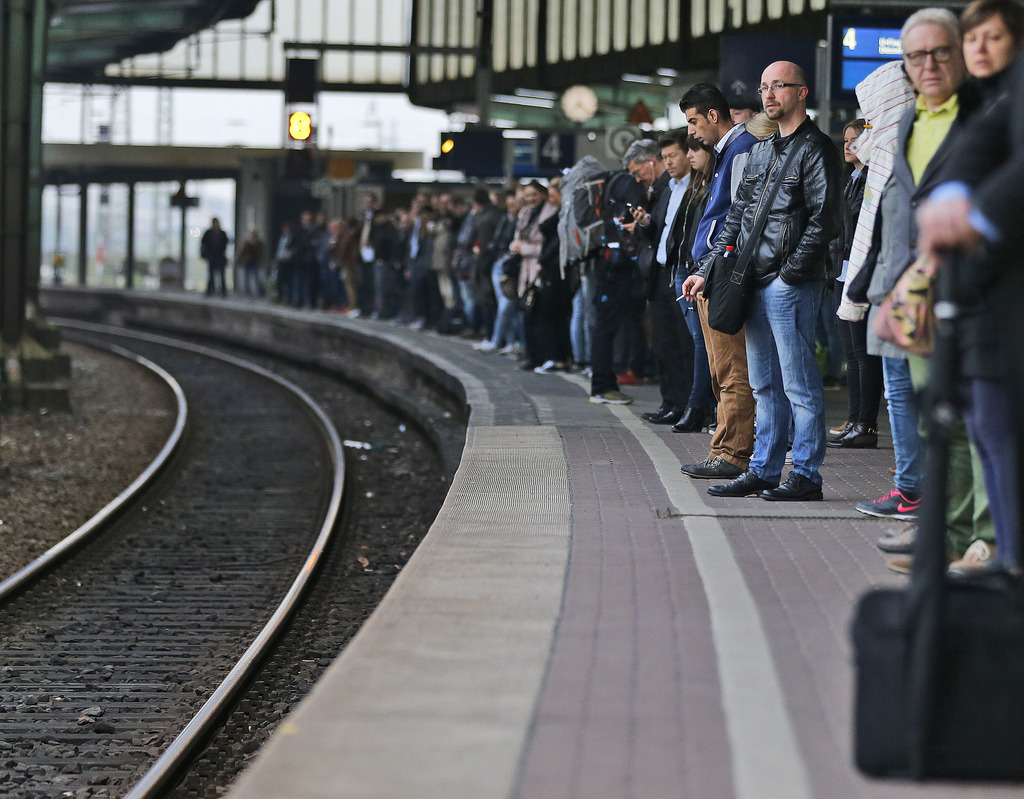Commuters queue for rare trains during rush hour and train drivers' strike at a main railway station in Duisburg, Germany, Wednesday, April 22, 2015. The GDL union said passenger services was hit from 2 a.m. (0000 GMT) Wednesday and will be untill 9 p.m. (1900 GMT) Thursday. Members on freight trains walked off the job Tuesday afternoon and return to work Friday morning.(AP Photo/Frank Augstein)