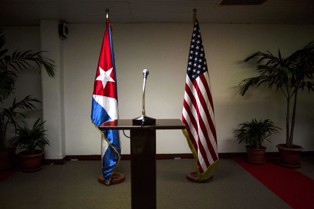 FILE - In this Jan. 22, 2015 file photo, a Cuban and U.S. flag stand before the start of a press conference on the sidelines of talks between the two nations in Havana, Cuba. The U.S. hopes to open an embassy in Havana before presidents Barack Obama and Raul Castro meet at a regional summit in April, which will be the scene of the presidents? first face-to-face meeting since they announced on Dec. 17 that they will re-establish diplomatic relations after a half-century of hostility. (AP Photo/Ramon Espinosa, File)