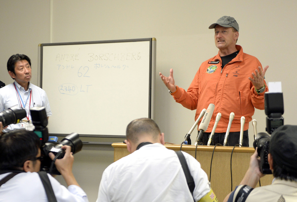 Swiss pilot Andre Borschberg speaks to journalists at the Nagoya Airport in Aichi prefecture, central Japan Tuesday, June 2, 2015 after his solar-powered plane attempting to circle the globe without a drop of fuel made an unscheduled landing in Japan to wait out bad weather. Borschberg took off from Nanjing, China, on Sunday on what was to be the longest leg of the journey, a six-day, 8,175-kilometer (5,079-mile) flight to Hawaii. Instead, the Solar Impulse 2 made an unscheduled visit late Monday and landed safely at the Nagoya Airport. (Kyodo News via AP) JAPAN OUT, MANDATORY CREDIT