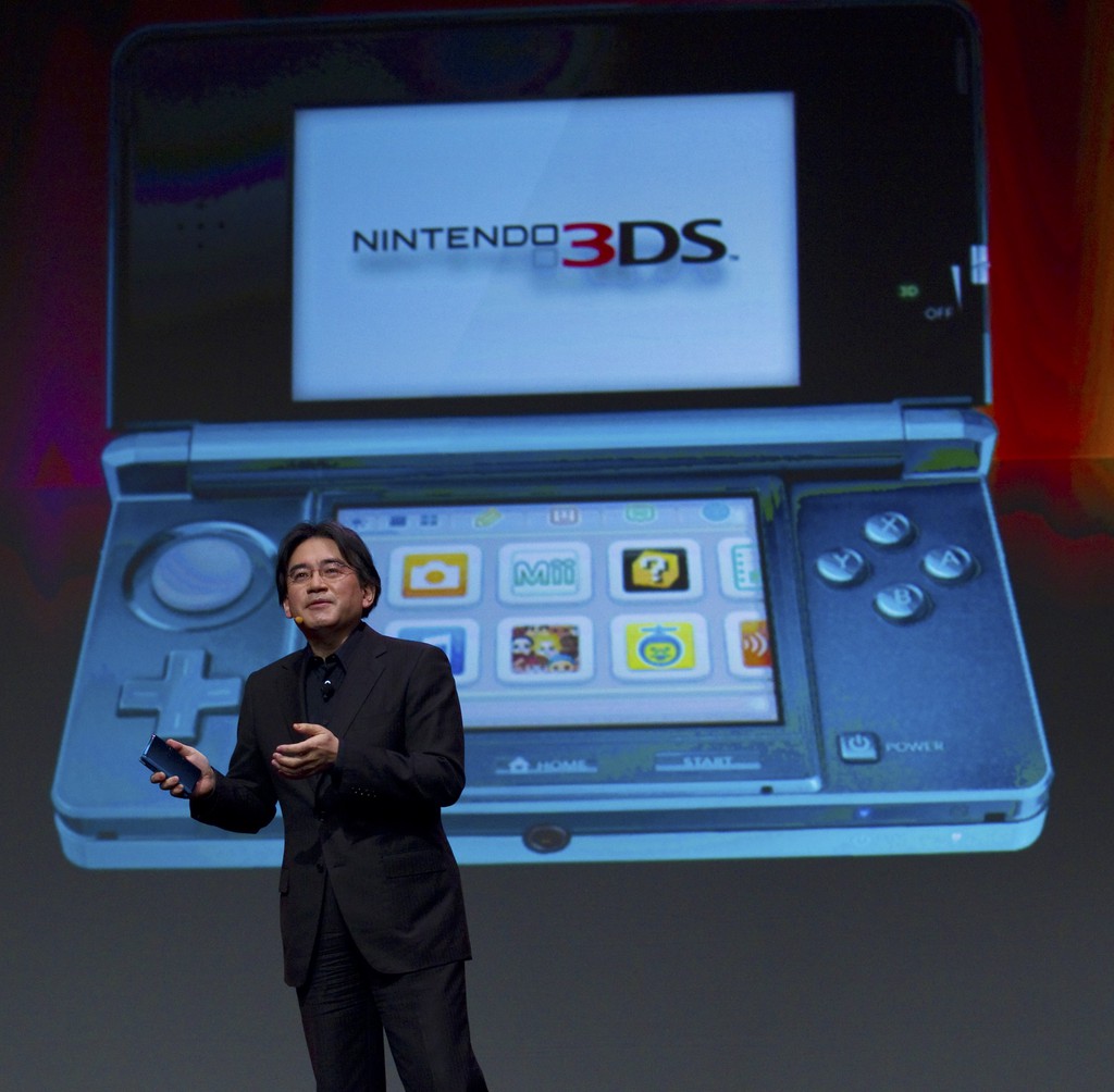 In this photo provided by Nintendo of America, Satoru Iwata, president of Nintendo Co. Ltd., showcases the Nintendo 3DS portable video game system at the Game Developers Conference in San Francisco on Wednesday, March 2, 2011. The Nintendo 3DS launches in the United States on March 27, 2011. (AP Photo/Nintendo of America, Kim White) NO SALES