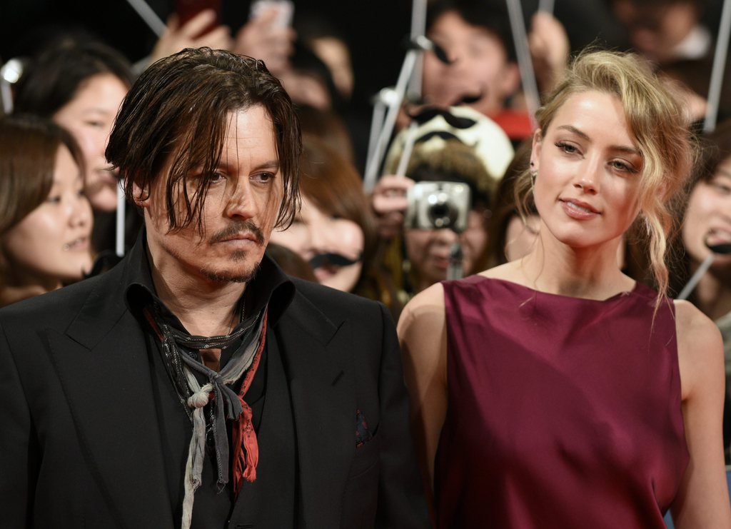 epa04588620 US actor/cast member Johnny Depp (L) and partner US actress Amber Heard (R) arrive for the premiere of 'Mortdecai' in Tokyo, Japan, 27 January 2015. The movie will be released in Japanese theaters on 06 February.  EPA/FRANCK ROBICHON