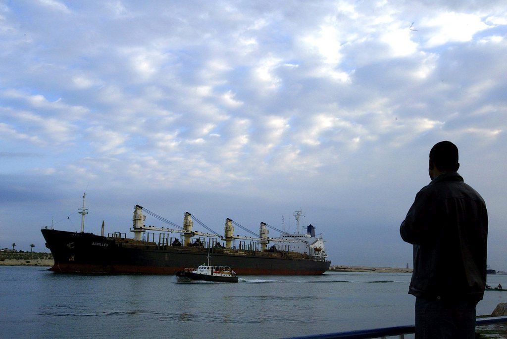 epa04872987 (FILE) A file photo dated 14 December 2004 showing a pilot boat guiding a ship through the Suez Canal as a man observes from the shore in Ismalia, Egypt. The enlarged Suez Canal - one of the world's most important waterways - is being officially opened on 06 August 2015. The new project is said to allow two-way traffic of tankers and freighters on the "New Suez Canal" instead of just one as has been the case until recently.  EPA/MIKE NELSON *** Local Caption *** 00329999 *** Local Caption *** 00329999