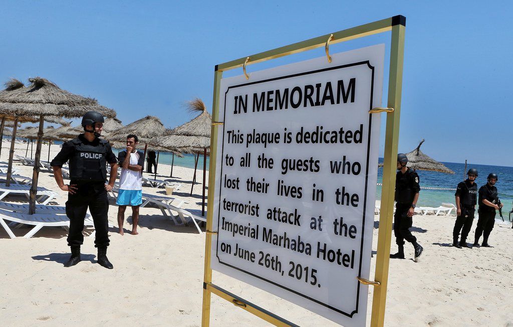 epa04829571 Members of the Tunisian security services stand guard during a memorial ceremony and minutes silence for the victims of a terror attack on a beach outside the Imperial Marhaba Hotel, in the popular tourist resort of al-Sousse, Tunisia, 03 July 2015. 38 people were killed, including 30 UK nationals, 26 June, when a gunmen opened fire on holidaymakers on a beach and in a hotel, before being killed by local security services, in a attack claimed by affiliates of the group calling themselves the Islamic State (IS), who have since vowed to carry out more attacks in the region.  EPA/MOHAMED MESSARA