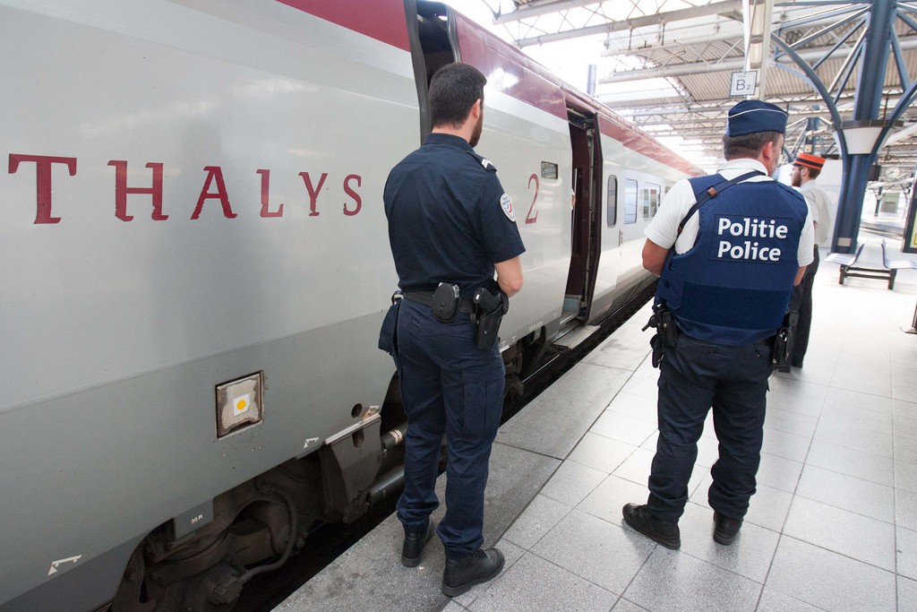 Member of belgian and french police stay next to a Thalys train at the Brussels Midi - Zuid train station, on Saturday, Aug. 22, 2015.  Security has become more visible after an attack on Friday of a Thalys train traveling from Amsterdam to Paris. (AP Photo/Francois Walschaerts)