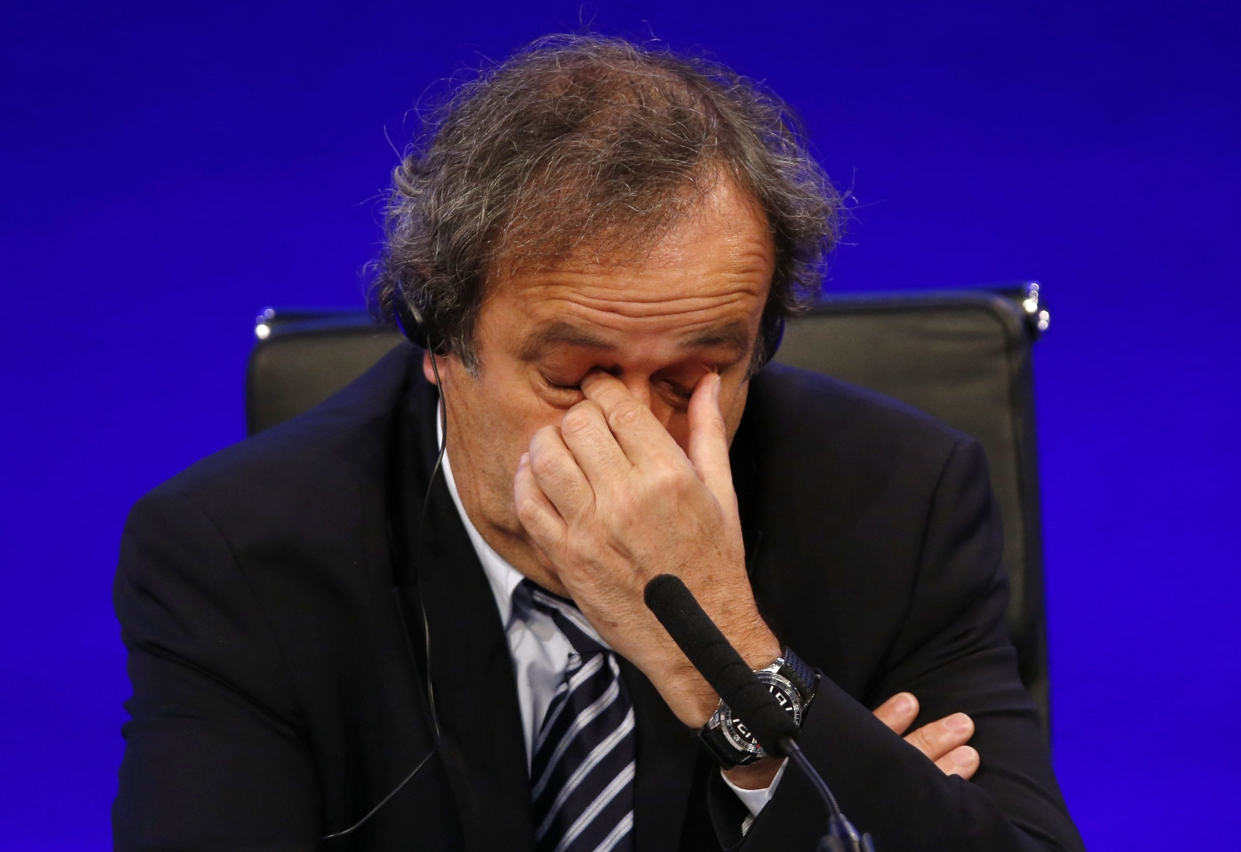 FILE - In this May 24, 2013 file photo UEFA President Michel Platini reacts as he speaks to members of the media at the end of the 37th Ordinary UEFA Congress in London. UEFA leaders were meeting Thursday Oct. 15, 2015 to decide whether to continue backing Michel Platini, with some not yet satisfied by his explanation for a payment that led to his 90-day FIFA suspension. (AP Photo/Sang Tan)