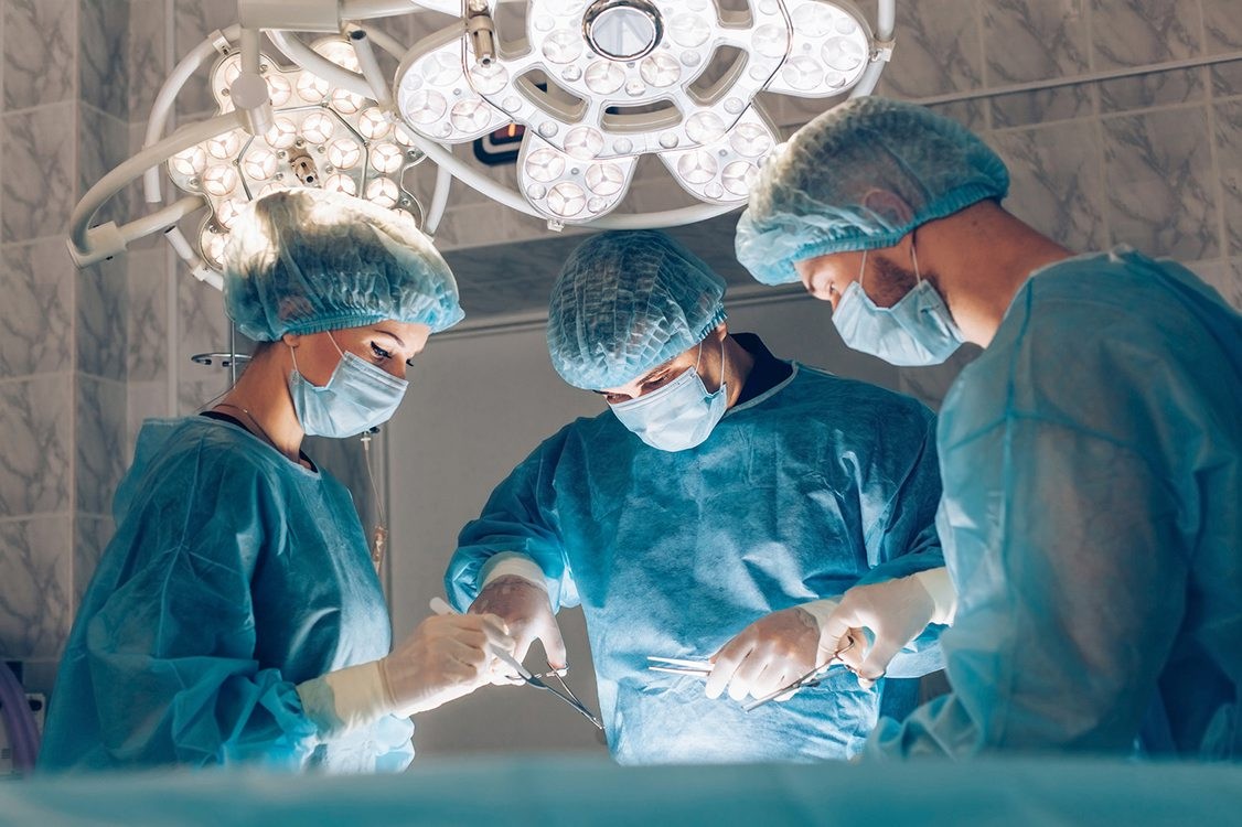 Surgeons team working with Monitoring of patient in surgical operating room. breast augmentation. Surgeons team working with Monitoring of patient in surgical