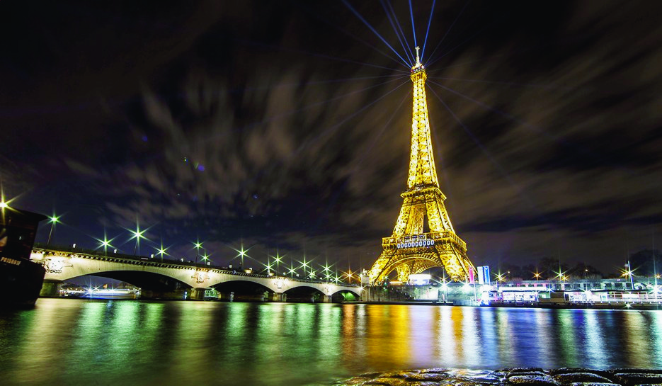 epa05057204 Beams of light are visible atop the Eiffel Tower, as part of a light installation entitled 'Human Energy' by artist Yann Toma drawing attention to human-generated power, on the sidelines of the COP21 Climate Conference, in Paris, France, 06 December 2015. The 21st Conference of the Parties (COP21) is held in Paris from 30 November to 11 December aimed at reaching an international agreement to limit greenhouse gas emissions and curtail climate change.  EPA/IAN LANGSDON