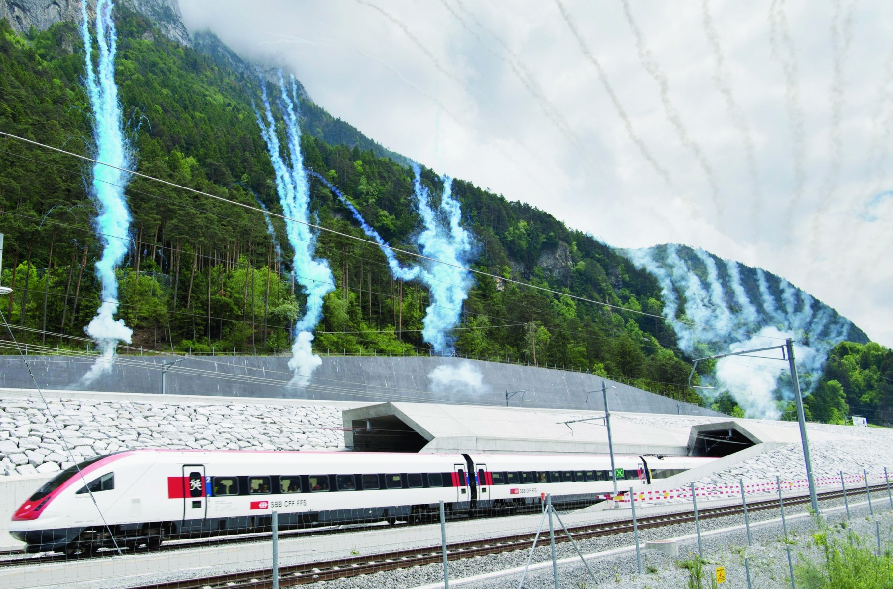 The first train comes out of the tunnel's North portal while fireworks mark the official opening on the opening day of the Gotthard rail tunnel, the longest tunnel in the world, at the North portal near Erstfeld, Switzerland, Wednesday, June 1, 2016. The construction of the 57 kilometer long tunnel began in 1999, the breakthrough was in 2010. After the official opening on June 1, the commercial opperation will commence on December 2016. (KEYSTONE/Laurent Gillieron) SWITZERLAND GOTTHARD TUNNEL OPENING