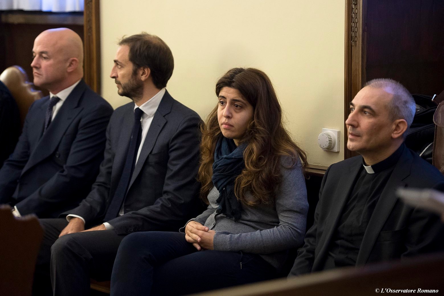 From left, Italian journalists Gianluigi Nuzzi and Emiliano Fittipaldi, public relations expert Francesca Chaouqui and Monsignor Angelo Lucio Vallejo Balda sit during their trial inside the Vatican, Tuesday, Nov. 24, 2015. Two Italian journalists who wrote books detailing Vatican mismanagement faced trial Tuesday in a Vatican courtroom along with three people accused of leaking them the information, in a case that has drawn scorn from media watchdogs. (L'Osservatore Romano/Pool Photo via AP) VATICAN SCANDAL