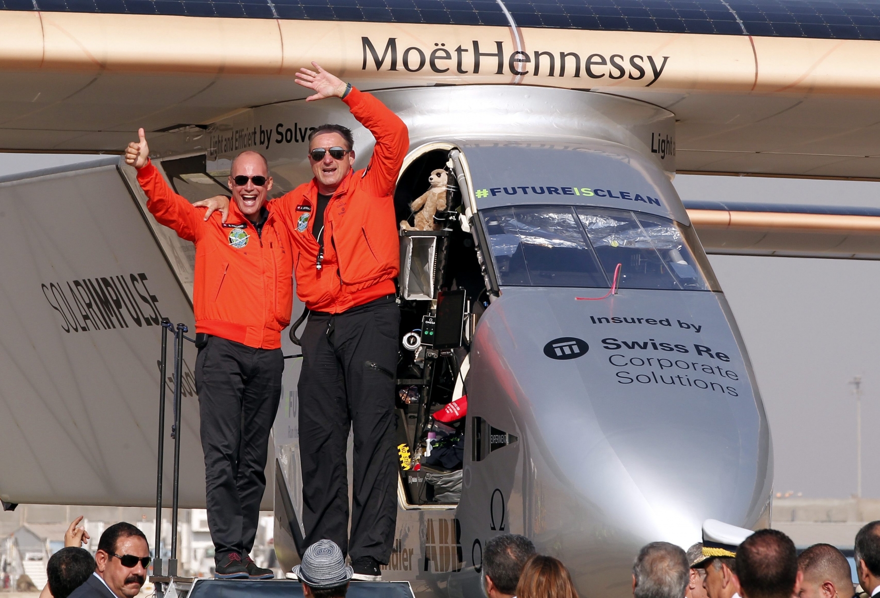 epa05422605 Swiss pilot Bertrand Piccard (L) and pilot Andre Borschberg (R) cheer after Solar Impulse 2, the solar powered plane, landed at Cairo International Airport in Cairo, Egypt, 13 July 2016. The 16th leg of the round-the-world-trip from Seville in Spain covered a distance of 3,700km and took almost 49 hours.  EPA/KHALED ELFIQI EGYPT SOLAR IMPULSE