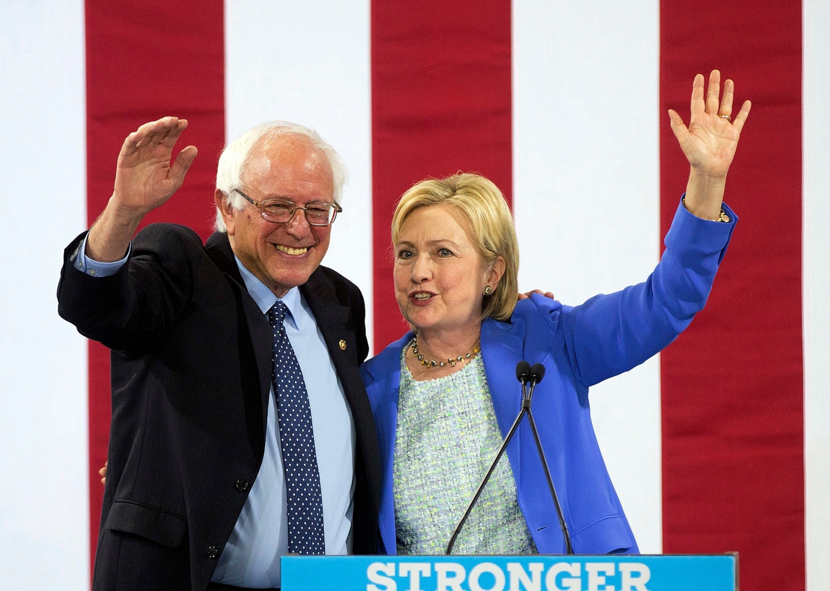 Democratic presidential candidate Hillary Clinton waves to supporters with Sen. Bernie Sanders, I-Vt., during a rally in Portsmouth, N.H., Tuesday, July 12, 2016, where Sanders endorsed her for president. (AP Photo/Jim Cole) APTOPIX Campaign 2016 Clinton Sanders