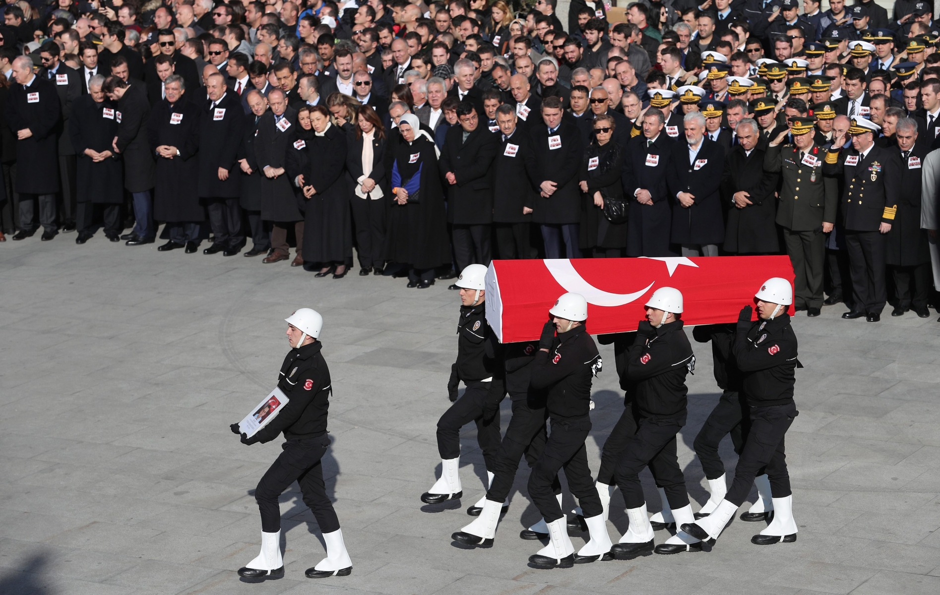 epa05670328 Police officers carry the coffin of a colleague who was killed in bomb attacks at the Vodafone Stadium in Besiktas a day earlier during the funeral in Istanbul, Turkey, 11 December 2016. At least 38 people were killed and 166 other wounded in two explosions outside Besiktas Stadium and in nearby Macka Park a few hours after the night's soccer match on 10 December. The bombs apparently targeted police officers who were securing the match.  EPA/SEDAT SUNA TURKEY BOMB ATTACK AFTERMATH