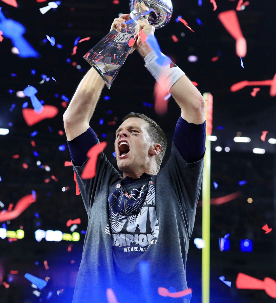 epaselect epa05774207 New England Patriots quarterback Tom Brady celebrates with the Vince Lombardi Trophy after the Patriots defeated the Falcons in overtime of Super Bowl LI at NRG Stadium in Houston, Texas, USA, 05 February 2017. The AFC Champion Patriots play the NFC Champion Atlanta Falcons in the National Football League's annual championship game.  EPA/TANNEN MAURY EPASELECT USA AMERICAN FOOTBALL SUPER BOWL LI