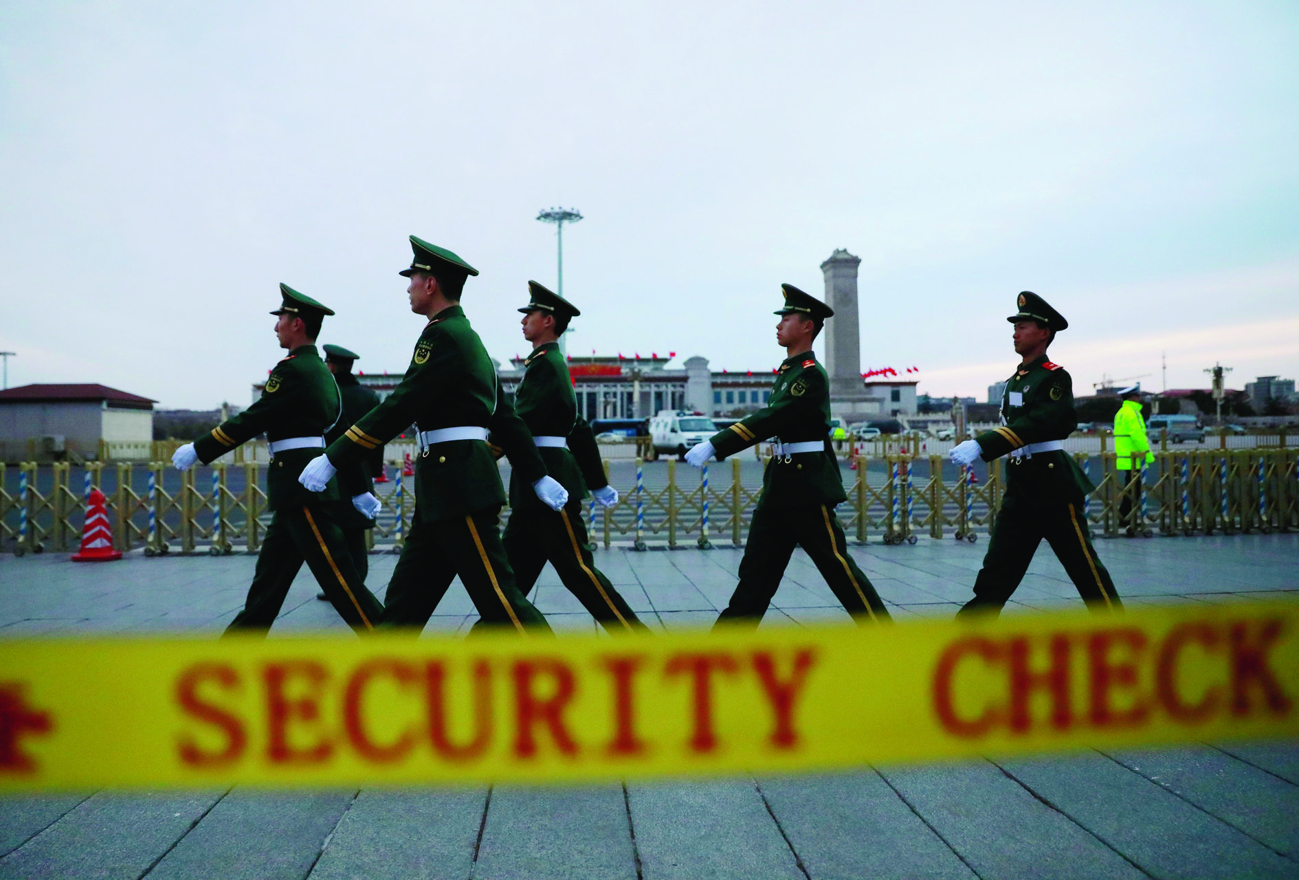 epa05830369 Chinese People's Liberation Army (PLA) soldiers march past the Great Hall of the People before the opening of the fifth Session of the 12th National People's Congress (NPC) in Beijing, China, 05 March 2017. The NPC has over 3,000 delegates and is the world's largest parliament or legislative assembly though its function is largely as a formal seal of approval for the policies fixed by the leaders of the Chinese Communist Party. The NPC runs alongside the annual plenary meetings of the Chinese People's Political Consultative Conference (CPPCC), together known as 'Lianghui' or 'Two Meetings'.  EPA/HOW HWEE YOUNG CHINA POLITICS NPC